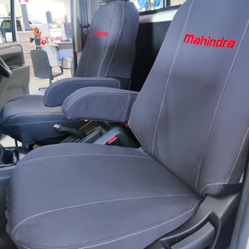 The is the seat for an S6 Mahindra single cab, in Charcoal grey with Red Mahindra printed on the back rest. - CamelThorn Canvas