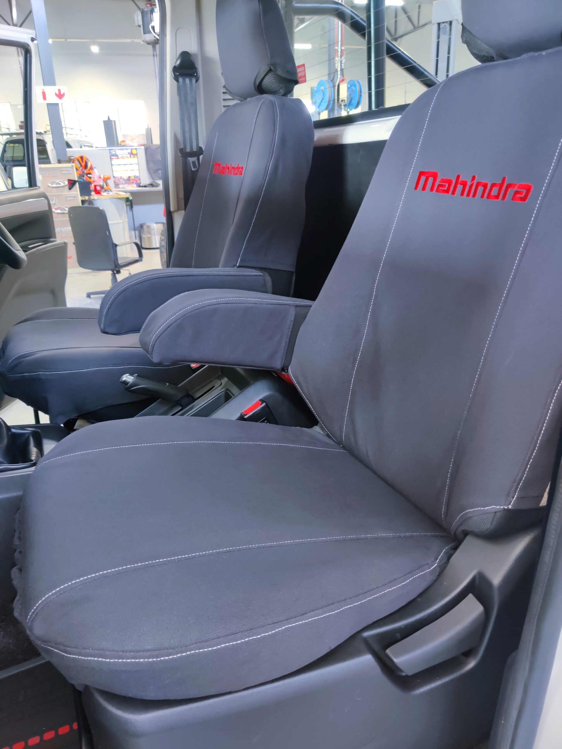 The is the seat for an S6 Mahindra single cab, in Charcoal grey with Red Mahindra printed on the back rest. - CamelThorn Canvas